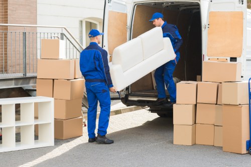 Careful loading of sofas and heavy furniture for collection in Bow