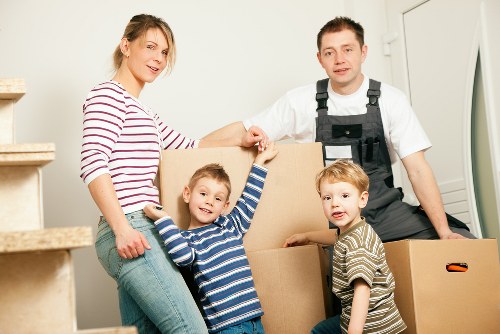 Worker using safe manual handling techniques with moving equipment