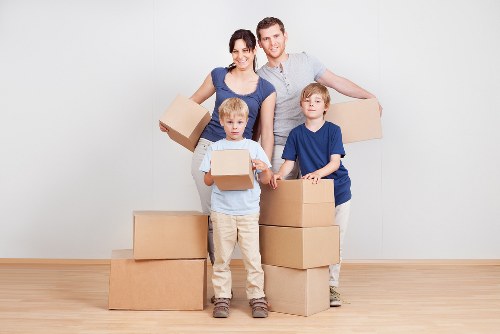 Packing boxes and furniture prepared for storage in Bow