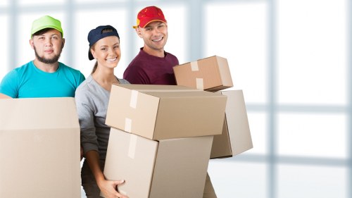 Professional movers loading items for a relocation in Bow