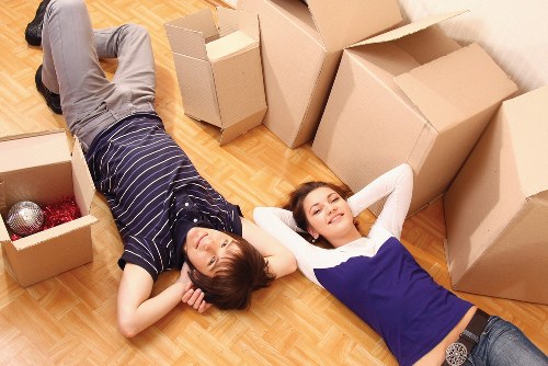 Professional movers loading furniture and boxes into a removal van